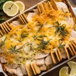 Million Dollar Chicken Casserole topped with golden breadcrumbs, served in a baking dish with creamy layers of shredded chicken, cheese, and herbs