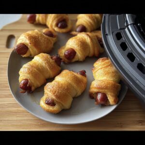 Plate of extra crispy Air Fryer Mummy Pigs in a Blanket with sausages.