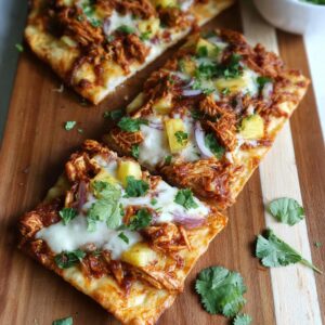 Delicious BBQ chicken flatbread pizzas topped with cheese and cilantro.