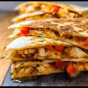 Close-up of chicken fajita quesadillas with melted cheese and red peppers.