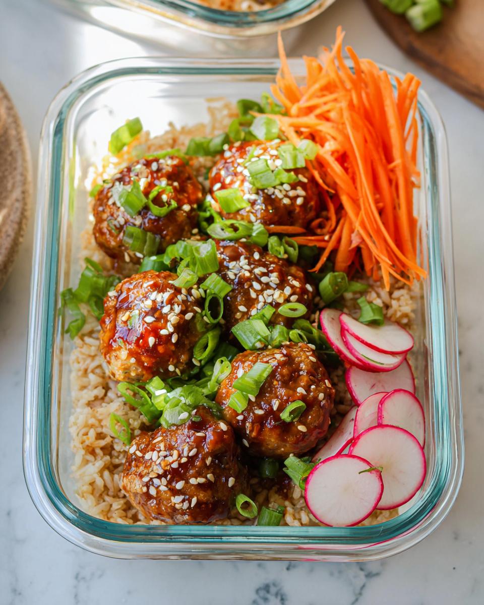 Maple-Sriracha cocktail meatballs served over rice with green onions and carrots.
