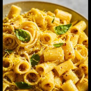 Close-up of One-Pan Lemon Garlic Pasta garnished with basil and lemon zest.